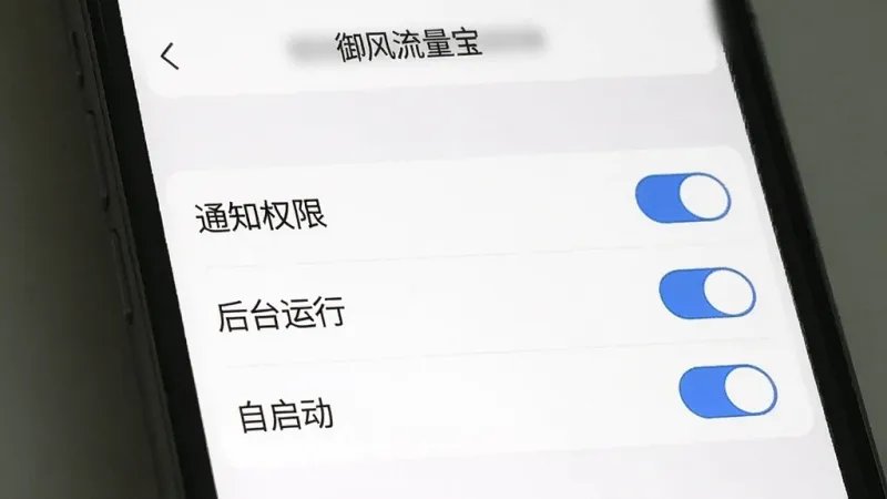 一张手机屏幕录制截图风格的图片,展示“御风流量宝”的权限设置引导页面,页面上有“通知权限”“后台运行”“自启动”等选项开关,开关旁边有蓝色对勾标记,背景是简洁的白色设置界面,风格清晰明了,画质干净无多余元素