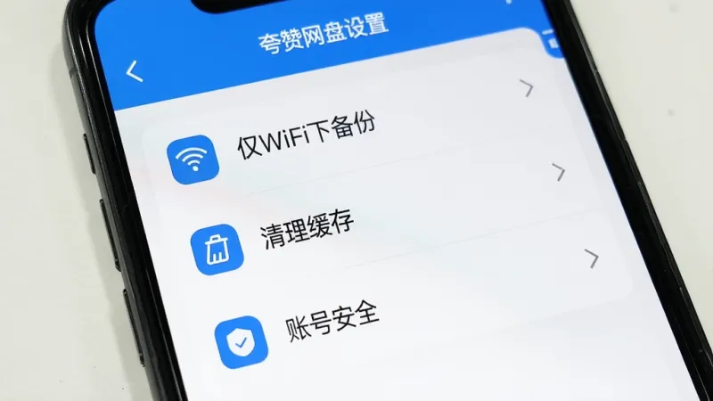 一张手机屏幕显示夸赞网盘设置页面的图片，页面中有“仅WiFi下备份”“清理缓存”“账号安全”等选项，界面简洁，蓝白配色，图标清晰，画质干净
